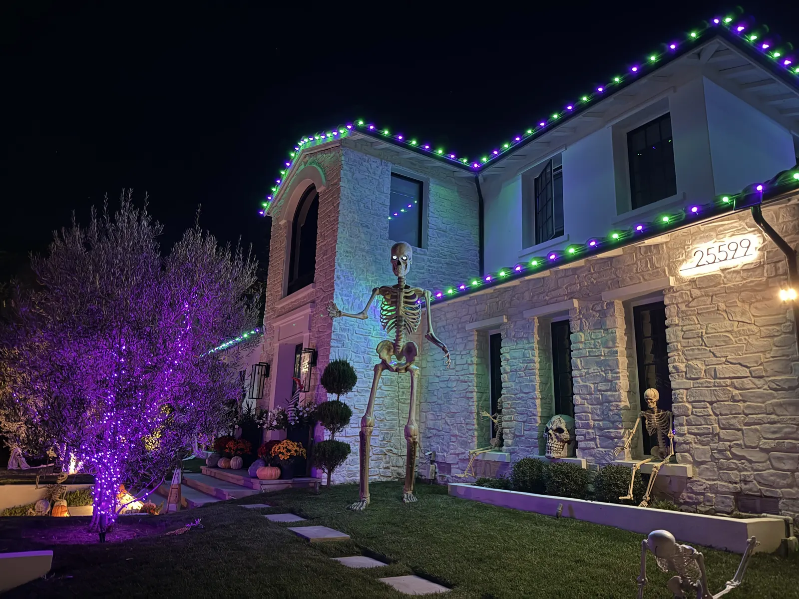 Halloween roofline lighting with skeleton decorations